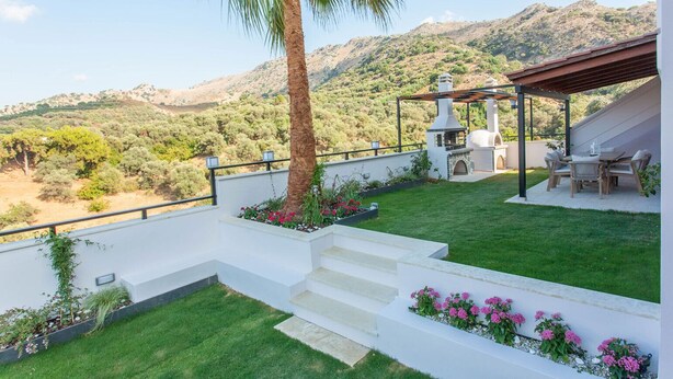 A terrace with a view of a hilly landscape, a barbecue area, and a seating arrangement. - Sound Of The Mountain Chania (Chania)
