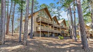 A lodge with a multi-story structure, large windows, and a balcony.