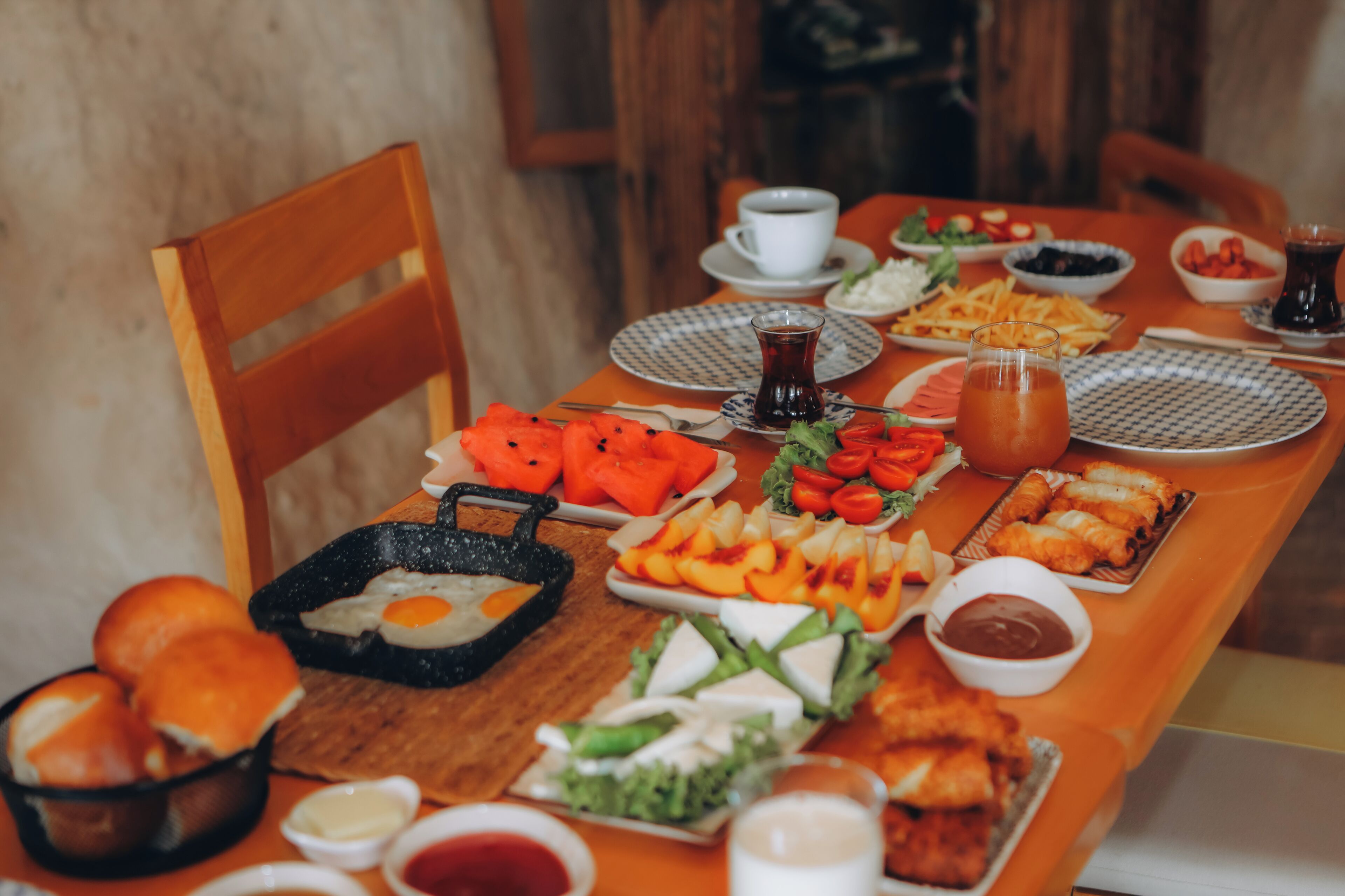 A dining table set with various dishes including eggs, salads, and bread.