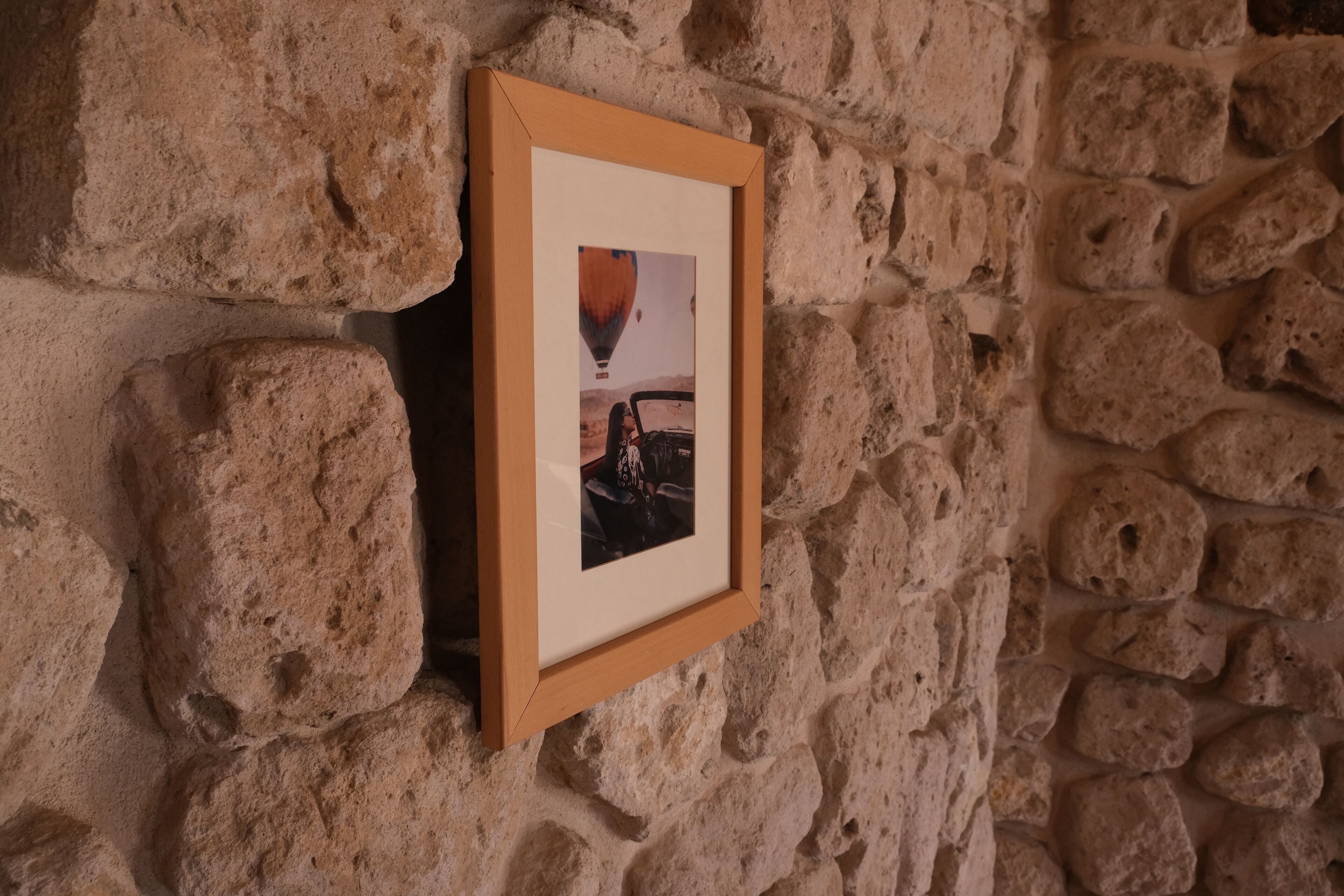 A framed photograph on a stone wall.