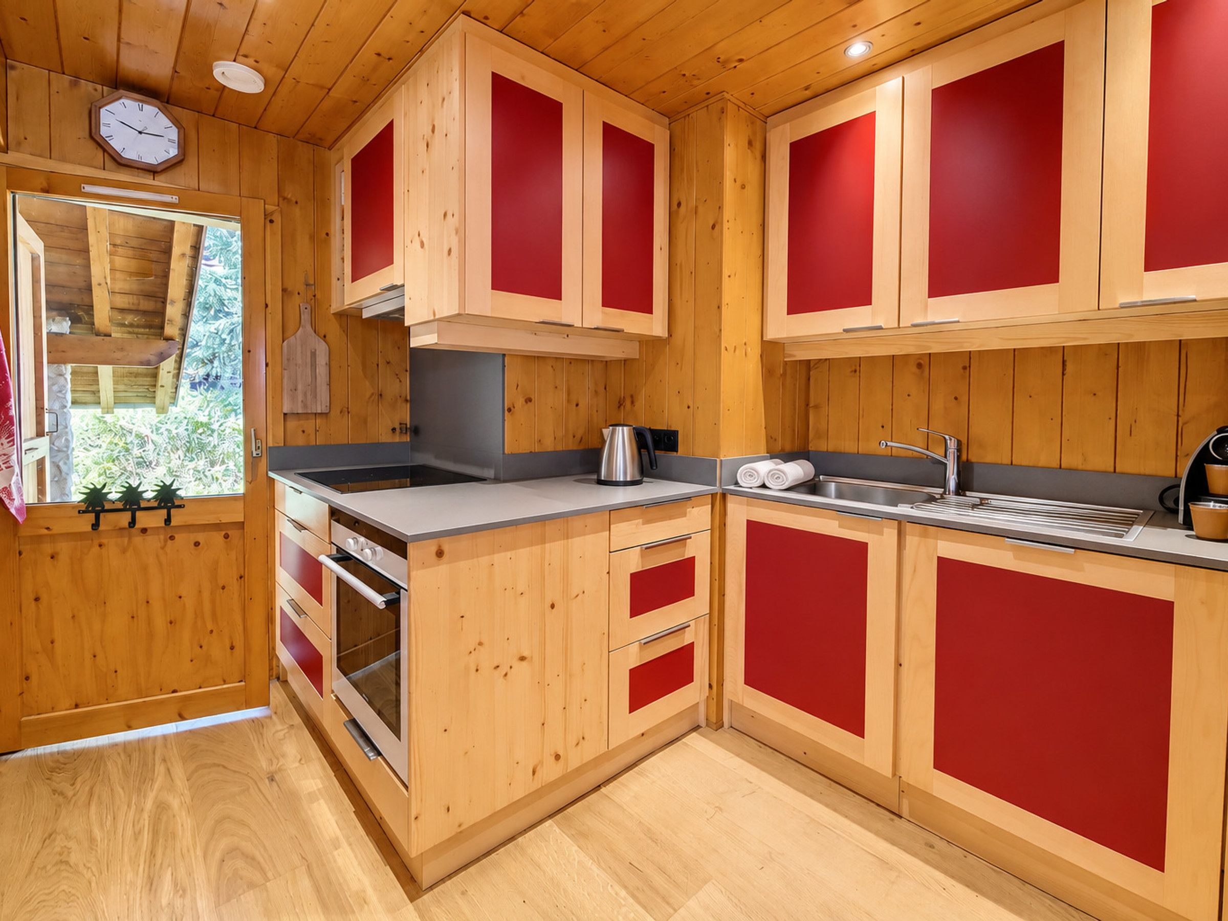 A compact kitchen with wooden cabinets and a built-in oven.