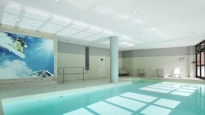 An indoor swimming pool with clear water, a mural of a snowboarder on a mountain, and a sunlit ceiling. - Flaine: 4R ski-in/ski-out, pool, parking, 8 people (Flaine)