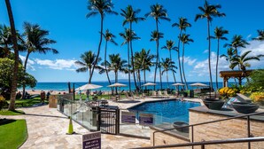 A pool area with a sign instructing to dry off and remove sand before entering the lobby.