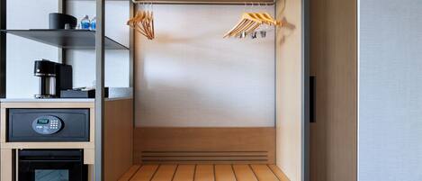 A compact kitchenette with a coffee maker, a microwave, and a small refrigerator.