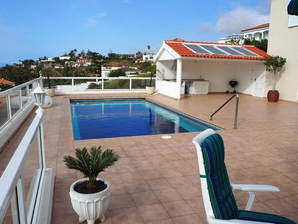 A rooftop pool with a clear view of the surrounding neighborhood, a covered seating area, and a potted plant. - Vacation Home "Hibiscus" with Sea View, Pool & Wi-Fi (santa ursula)