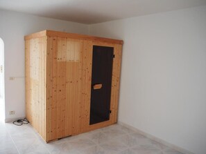 A room with a wooden wardrobe, a tiled floor, and a plain wall. - Vacation Home "Hibiscus" with Sea View, Pool & Wi-Fi (santa ursula)