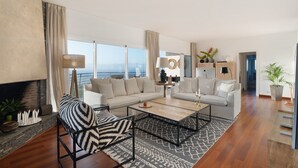 A modern living room with a sofa, armchairs, a coffee table, and a fireplace. - Vacation Home "Villa Bahía de Michel" with Sea View, Pool, Garden & Wi-Fi (santa ursula)
