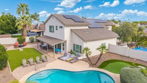 A residential property with a swimming pool, a covered patio, and solar panels on the roof. - 5BR|Heated Pool|Pickleball| Ping Pong & Pool Table (Chandler)