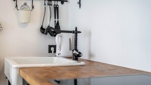 A kitchen with a white sink, a wooden countertop, and a coffee maker. - Holiday Apartment "Binderhof Apt Obm" with Mountain View, Private Terrace and Wi-Fi (Brixen)
