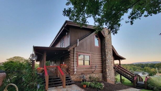 A rustic log cabin with a stone pathway leading to a wooden staircase. - 20% OFF Lake View Retreat- Lake & Mountain View, Hot Tub, Fire Pit, Porch Swing (Dandridge)
