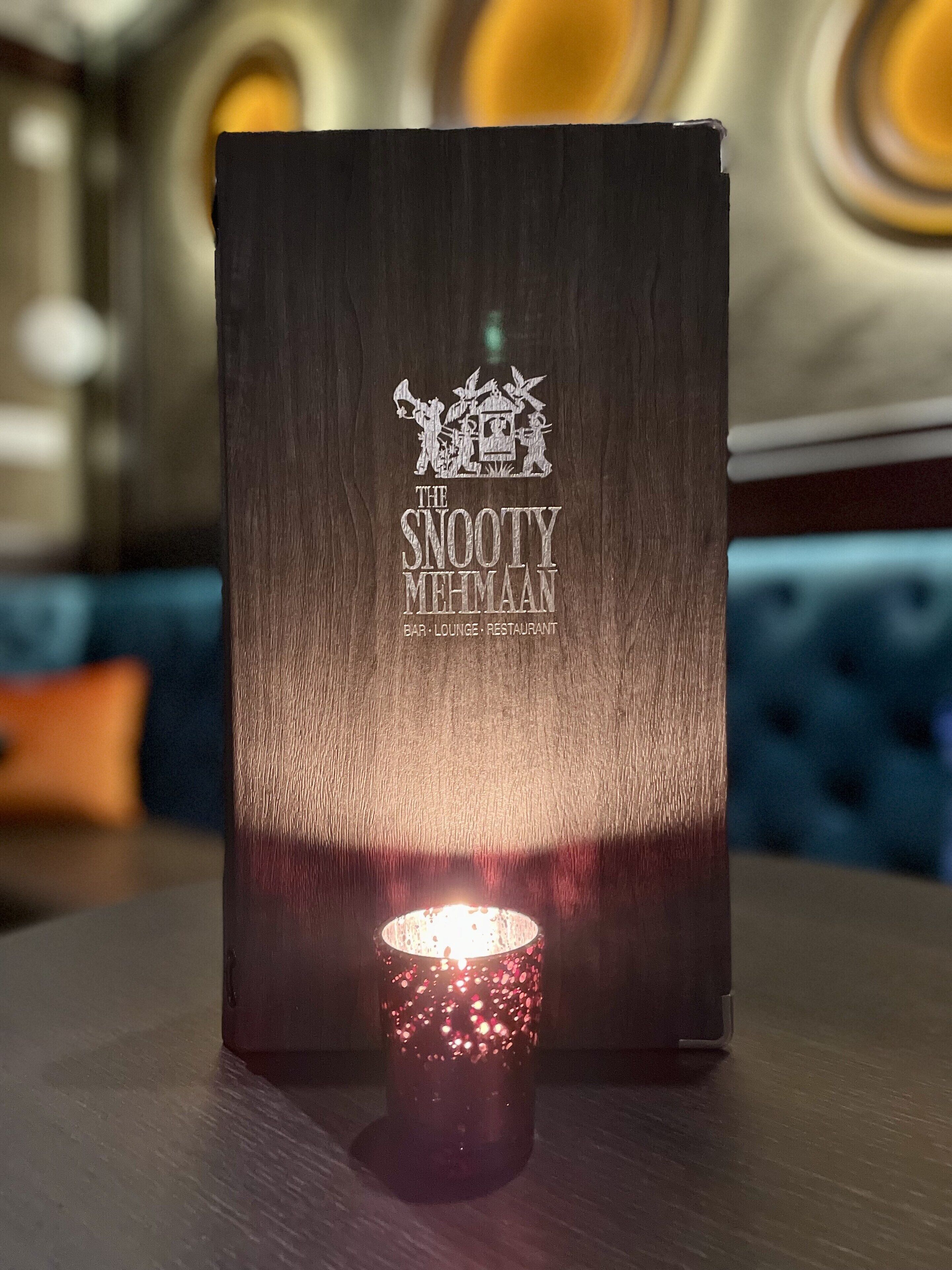 A menu board for The Sooty Mehmaan bar, lounge, and restaurant.