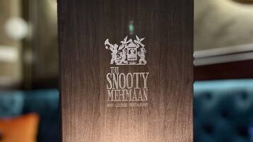 A menu board for The Sooty Mehmaan bar, lounge, and restaurant.