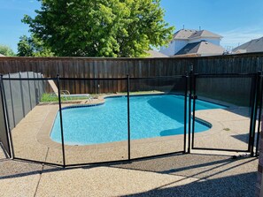 A backyard with a swimming pool surrounded by a fence. - Luxurious home /Pool/GameR/BBQ/kingbed/legacyW/Frisco (plano)