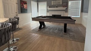A pool table in a room with a ceiling fan, a door, and a window with blinds. - Luxurious home /Pool/GameR/BBQ/kingbed/legacyW/Frisco (plano)