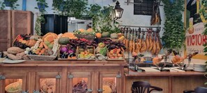 A market stall with various fresh produce and meats displayed in baskets and hanging racks. - Authentic Spanish townhouse in charming beach community - 60 steps to the beach! (Estepona)
