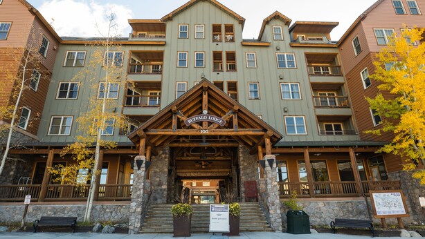 A multi-story hotel with a prominent entrance, stone steps, and wooden railings. - Remodeled modern ski-in/ ski-out condo in Keystone, 1 bd/1 ba, sleeps 4 (Keystone)