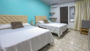 A hotel room with two beds, a bathroom, and a TV. - PB-T15 HABITACION DOBLE EN BARU CON WIFI (Cartagena)