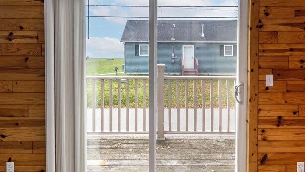 A wooden interior with a sliding glass door leading to a balcony. - Catch on the Canal - Waterfront Getaway Near Casino, Dining & Entertainment (Standish)