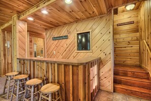A wooden interior with a bar area, stools, and a sign reading "The Gathering Place". - Rocky View Lodge - Private Lodge in Hocking Hills (Laurelville)