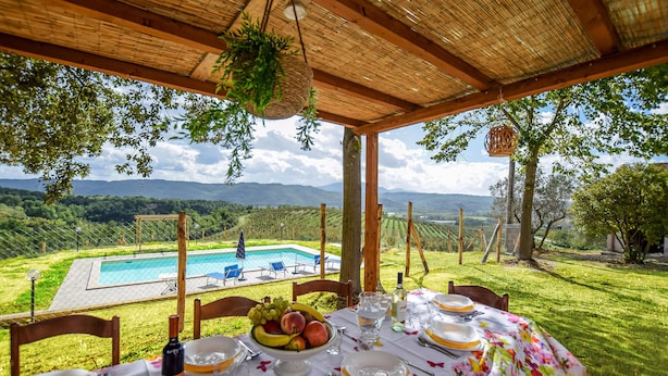 A table set for dining with a view of a swimming pool and mountains in the background. - Gorgeous home in Giove (Giove)
