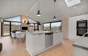 Enjoy cooking in this well-equipped kitchen with a large island, dishwasher, and stainless steel oven.