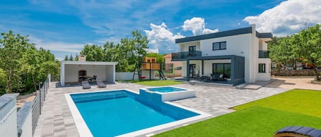 Outdoor pool, a heated pool, pool loungers