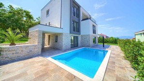 A modern two-story house with a swimming pool, stone walls, and a balcony. - Holiday apartment with pool and air conditioning (Njivice)