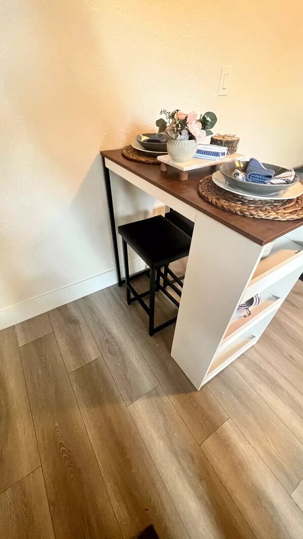 Compact kitchenette with bar stool, perfect for preparing meals.