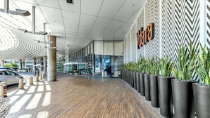 A modern building with a zigzag patterned wall and a sign that reads "Viva".