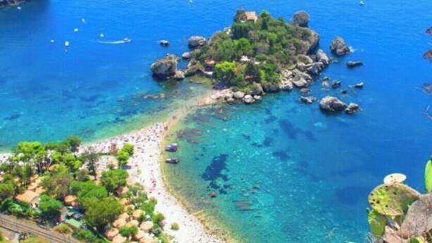A coastal area with a beach, rocky outcrops, and clear blue water. - The little house on the sea (Venetico Marina)