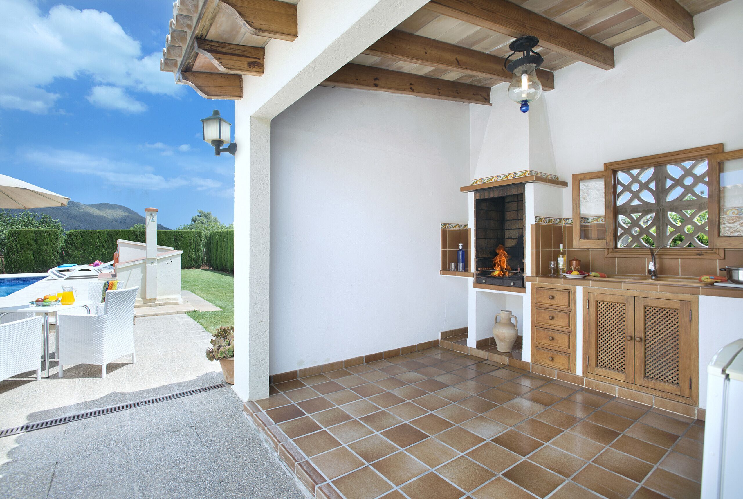 A kitchen with a tiled floor, wooden cabinets, and a built-in stove.