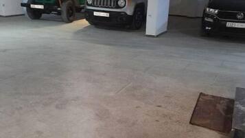 Eine Parkgarage mit drei Fahrzeugen in markierten Stellplätzen.