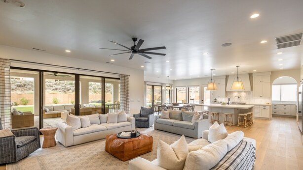 A spacious living area with a large sofa set, a coffee table, and a kitchen in the background. - Sleeps 25, Private Pool, Hot Tub & Courts, Playground (St. George)