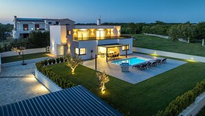 A modern two-story house with a swimming pool, outdoor seating, and well-maintained landscaping. - Villa Ana Skicini in Jursici (Jursici)