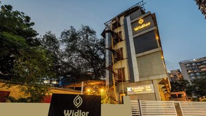 A hotel named Widlor with a signboard, a staircase, and a gated entrance. - Treebo Premium Widlor Boutique (Mumbai)