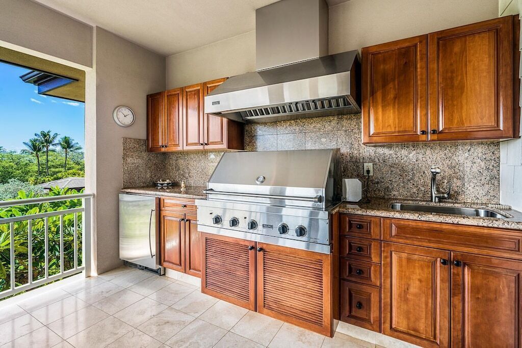 A kitchen with wooden cabinets, a stainless steel stove, and a granite countertop.