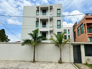 Stylish two-story building with a flat roof and second-floor balcony.