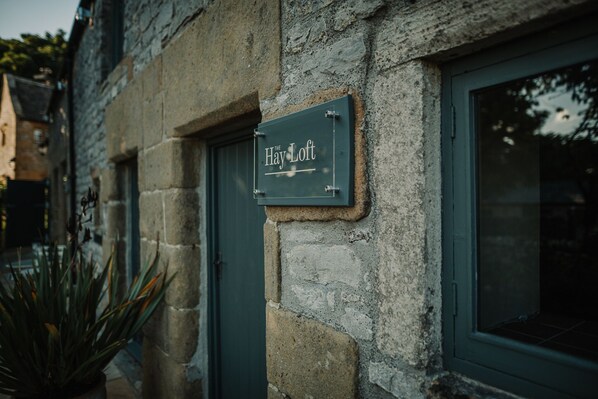 A stone building with a sign reading "The Hay Loft." - Countryside views, Rural first floor cottage (Buxton)