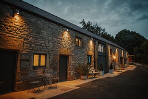 A stone building with a sign reading "Hay Loft" and outdoor seating. - Countryside views, Rural first floor cottage (Buxton)