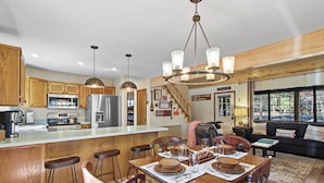 A modern kitchen with wooden cabinets, stainless steel appliances, and a central island. - Tranquil Pinetop Getaway! w/Firepit, Grill, Deck, Pet-Friendly, Near Ski & Golf! (Pinetop)