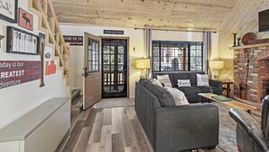 A cozy living room with a fireplace, a sofa, and a coffee table. - Tranquil Pinetop Getaway! w/Firepit, Grill, Deck, Pet-Friendly, Near Ski & Golf! (Pinetop)