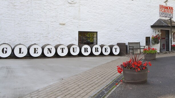 A white building with barrels spelling out "GLENTURER" and a sign reading "The Famous Grouse Experience." - A lovely hideaway in the heart of historic Crieff. (Crieff)
