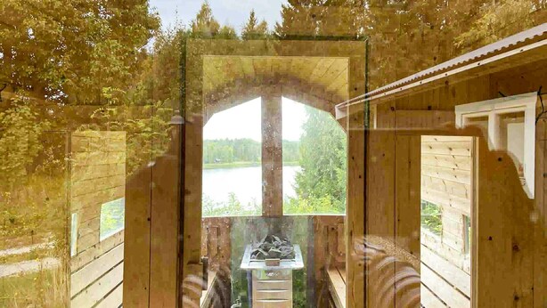 A sauna with a view of a lake, wooden walls, and a bench. - Cozy home in Harmånger with lake view (Harmånger)