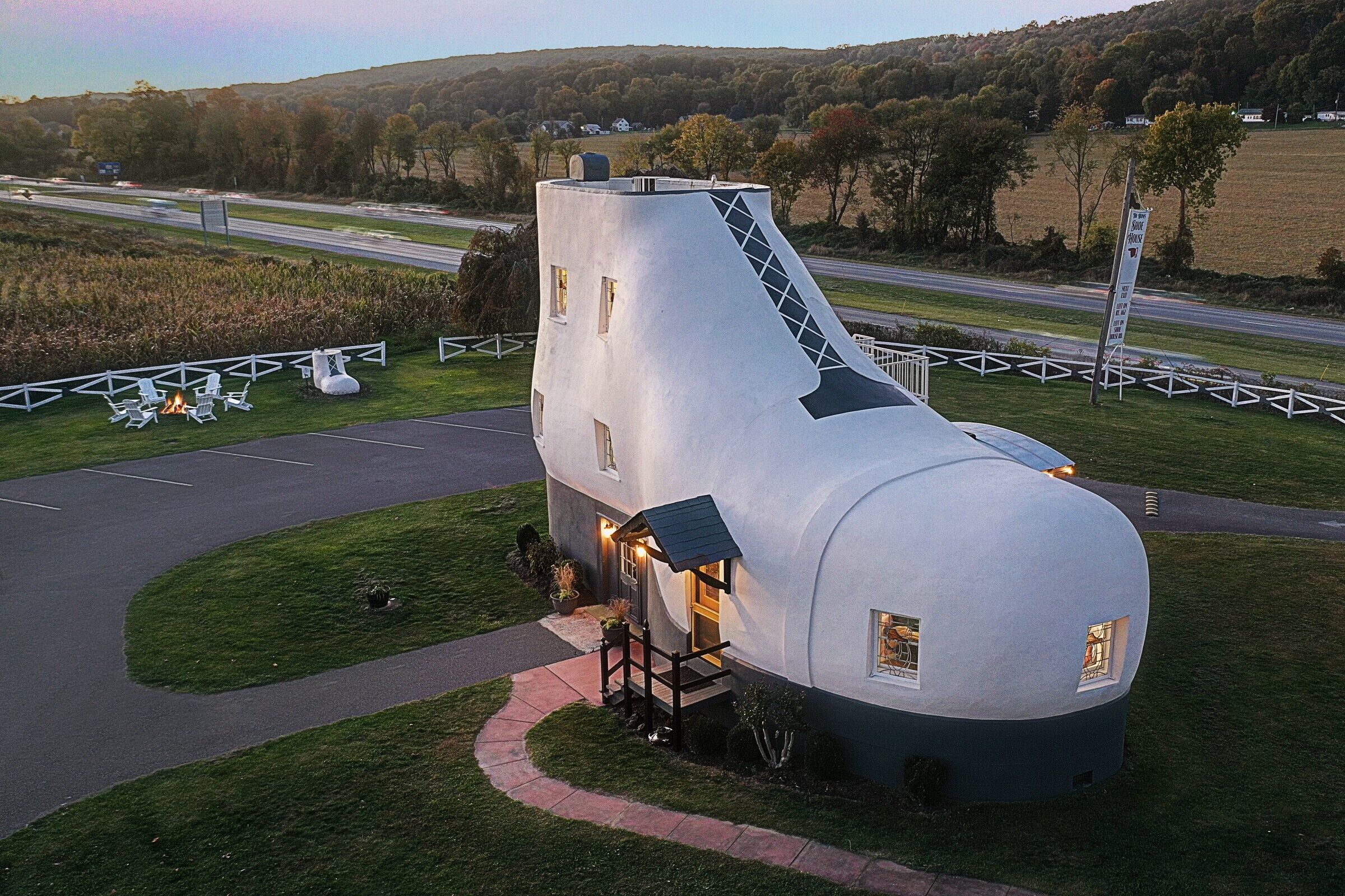 A unique, modern house with a large, rounded dome and a steep, triangular extension.