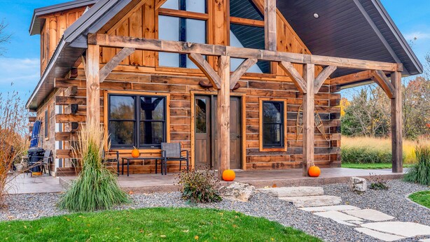 A log cabin with a large porch, multiple windows, and a stone pathway leading to the entrance. - Rustic Hideaway Sleeps 4 HOT TUB (De Soto)