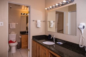 A bathroom with a sink, mirror, and hairdryer. - 28% OFF WALK TO LIFTS Sweetwater Lift Lodge 2-Bedroom 1/3/2026 thru 1/10/2026 (Park City)