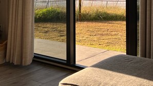 A room with a large sliding glass door leading to a beach view. - Beautiful Ground Floor with a Panoramic View of the Gulf of Mexico (Orange Beach)