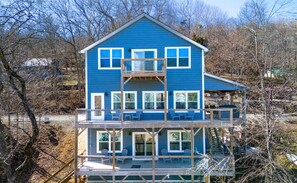 A two-story house with a balcony and a covered porch. - Entertainment in Abundance, Putting Green, Games, Kayaks, No-wake Covered Dock! (Speedwell)