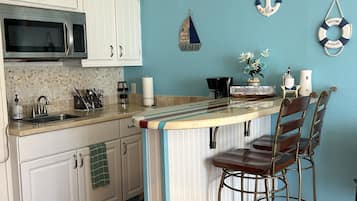 Fridge, microwave, stovetop, coffee/tea maker