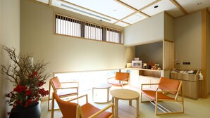 A modern room with a large window, a potted plant, and a kitchenette. - aduminoyu onyado nonomatsumoto (Matsumoto)
